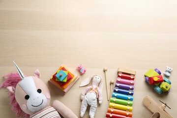 Poster - Different toys on wooden background, flat lay. Space for text