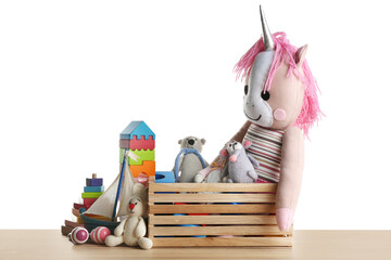 Poster - Set of different toys on wooden table against white background