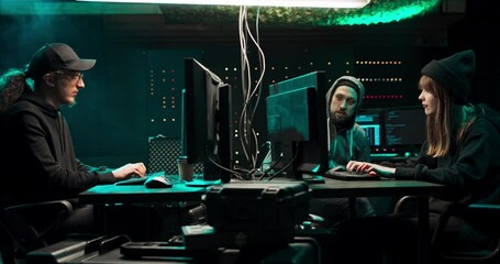 Group of Teenage Hackers Organize Attack on Corporate Data Servers. Their hideout is Dark and Full of Operating Displays.