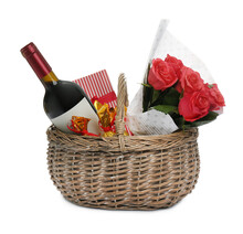 Wicker Basket With Gift, Bouquet And Wine On White Background