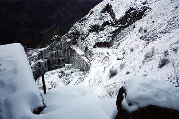 the mountains of the Apuan Alps covered with white snow in winter in Tuscany