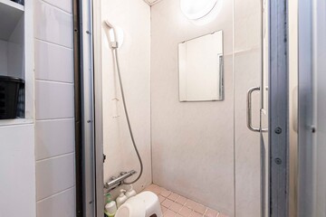 Shower in a small prefabricated shower room in a budget hotel