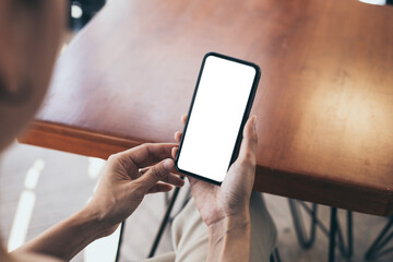 cell phone blank white screen mockup.woman hand holding texting using mobile on desk at office.background empty space for advertise.work people contact marketing business,technology