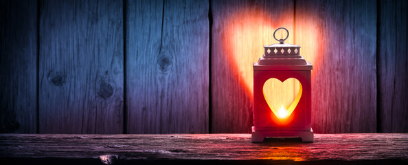 

Lantern With Heart Shaped Light On Wooden Table - Valentine Concept