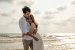 © Garun Studios - Young couple embracing on the beach in the sunset.Summer in love,Valentine day concept.