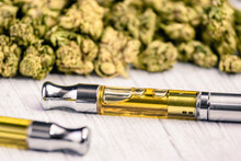 Cannabis Vape Pens Up-close With Cannabis On White Wooden Table