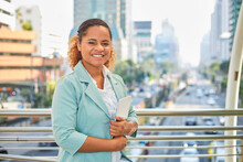 African American Woman Worker Walks In A Trendy Business District With A Tablet.