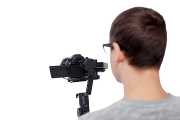 Wall Mural - back view of professional videographer shooting video with dslr camera on gimbal stabilizer isolated on white