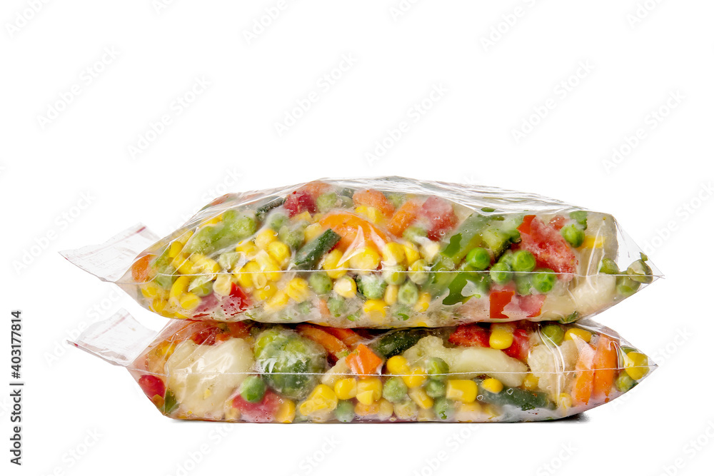 Frozen vegetables in plastic bags on white background