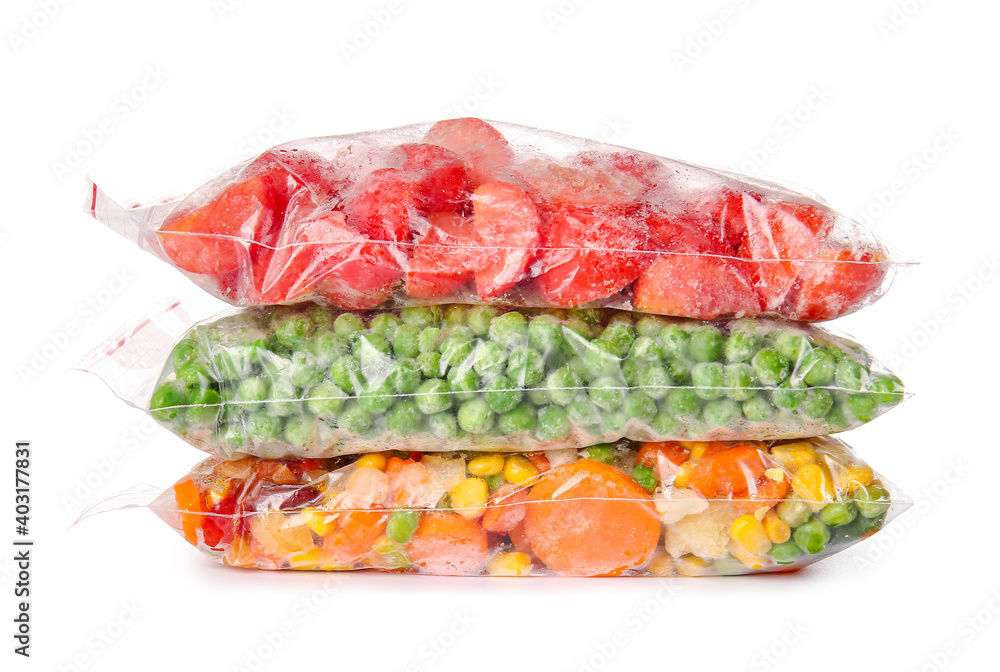 Frozen vegetables in plastic bags on white background