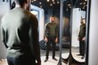 Stylish casual african american man at fitting room clothes store, looking on mirror. The concept of stylish men's clothing.