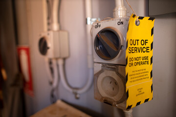 Safe workplaces practices yellow out of service warning tag placing on damaged faulty goods internal power point equipment      