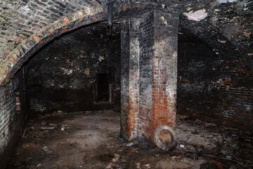 The basement of an old house with a domed vault and a supporting column. The picture was taken in Russia, in Orenburg