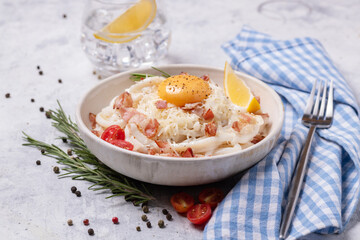 Classic carbonara pasta with fried bacon, parmesan cheese and egg yolk.