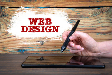 Wall Mural - web design concept. tablet on a wooden table. woman's hand writes and draws on a computer