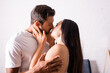 © LIGHTFIELD STUDIOS - sensual young couple kissing in bedroom