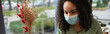 © LIGHTFIELD STUDIOS - african american woman in medical mask in cafe, banner