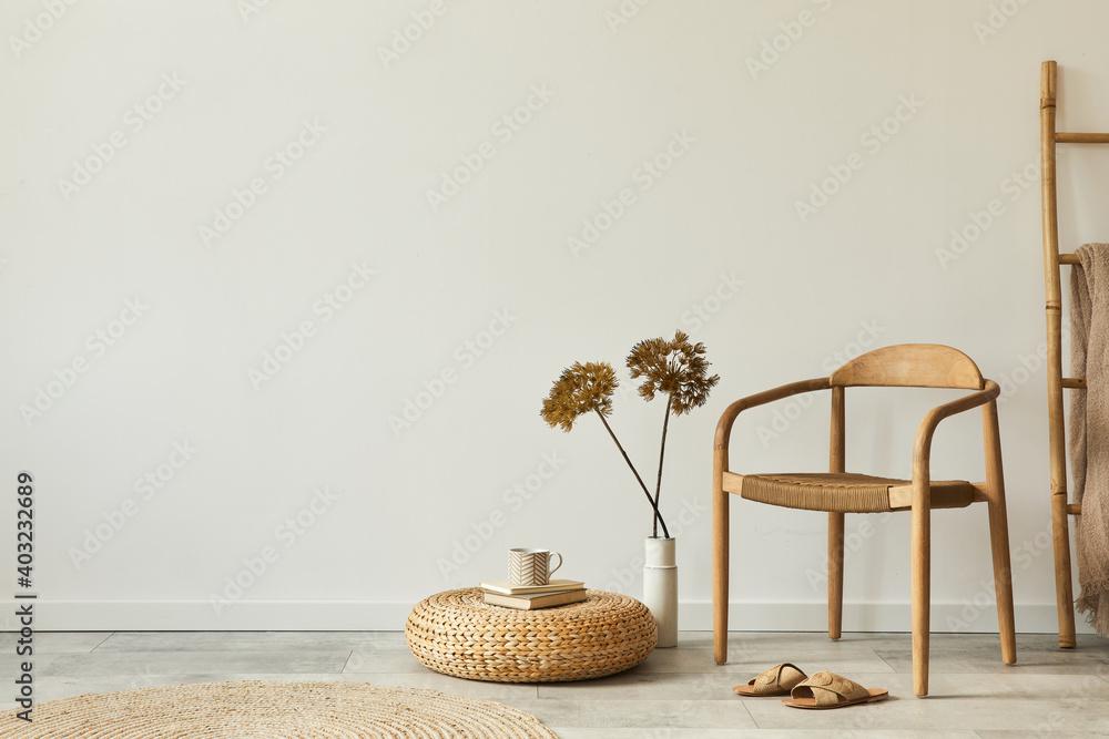 Neutral concept of living room interior with design wooden chair, round carpet, dried flowers in vase, stool, slippers, decoration and elegant personal accessories. Template. Copy space. - obrazy, fototapety, plakaty 