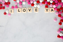 The Words I Love Ya Written In Scrabble Tiles On A Marble Kitchen Counter Top Surrounded By Valentines Candy