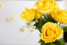 Yellow Roses Flat Lay Against A White Background