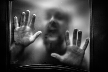 scary picture of hands behind glass