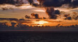 Sonnenuntergang vor Wolken auf dem Meer
