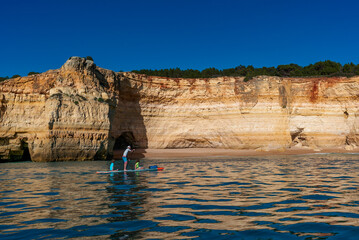 Sticker - father and twho young children paddle on a SUP board along the Algarve coast in Portugal