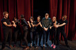 © standret - With rope in hands. Group of actors in dark colored clothes on rehearsal in the theater