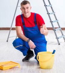 Wall Mural - Male painter preparing for painting job at construction site