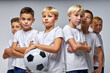 © Roman - soccer players after final game, confidently looking at camera. sports portrait of young football players. football youth junior team posing at camera, standing with crossed arms