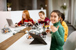 © BGStock72 - Happy kids programming electric toys and robots at robotics classroom