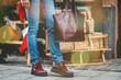 © Mykola - stylish woman walking on a street, winter fashion trend, legs close up, accessories, boots and bag