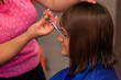 © MuamerO - Professional female hairdresser cutting girl's hair in salon