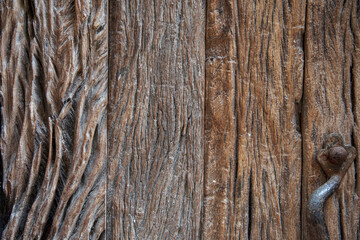 Textured natural wood background with golden highlighted grooves. Ancient wood in detail, grooves and veins, artistic composition. Old plank wooden wall background. The texture of old wood. Weathered