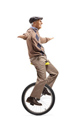 Wall Mural - Full length profile shot of an elderly man riding a mono-cycle and spreading arms