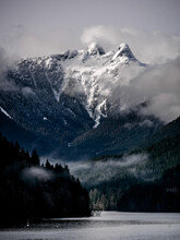 Lions Peak Mountain In The Fog. Clouds And Snow From Cleveland Dam And Capilano Lake