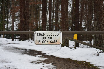 Road closed do not block gate metal gate sign with snow