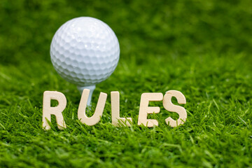 Wall Mural - Rules word with golf ball behind for rules of golf on green grass