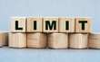 LIMIT - word on wooden cubes on a beautiful gray background