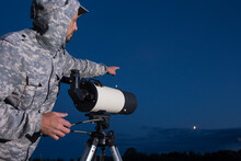 The Man Looks Through A Telescope. An Amateur Astronomer Observes The Sky.