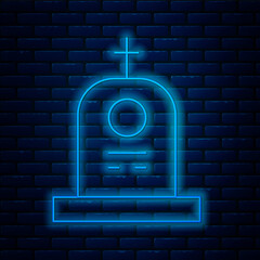 Poster - Glowing neon line Grave with tombstone icon isolated on brick wall background. Vector.