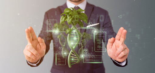 Wall Mural - Businessman holding a DNA growing as a plant - 3d rendering