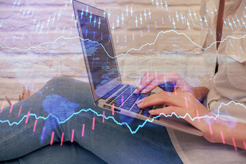 Multi exposure of woman hands typing on computer and forex chart hologram drawing. Stock market analysis concept.