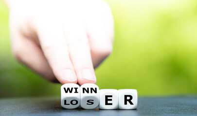 Wall Mural - Hand turns dice and changes the word loser to winner.