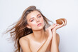 © Julia - Attractive Model girl with perfect Healthy radiant Skin on her Face and light wet Makeup. Hair. Beautiful girl holds a half Coconut in her hand. Beauty and Care