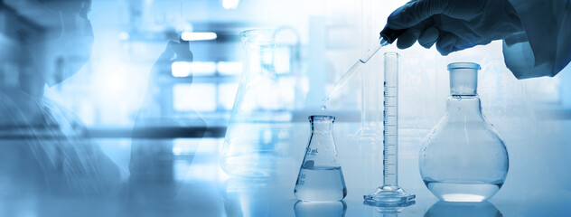 Wall Mural - hand of scientist with test tube and flask in medical chemistry lab banner background