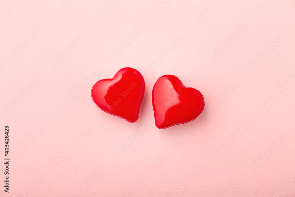 Two love hearts on pink background - obrazy, fototapety, plakaty 