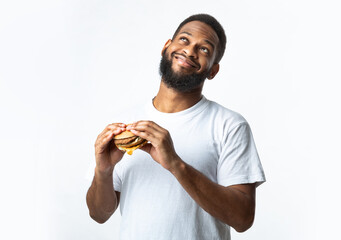 Wall Mural - Happy Black Millennial Guy Holding Tasty Burger, White Background