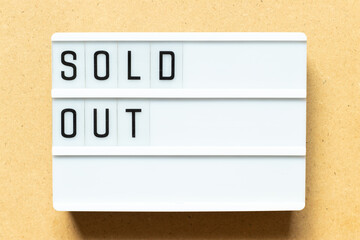 Sticker - Lightbox with word sold out on wood background