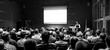 © kasto - Speaker Giving a Talk at Business Meeting. Audience in the conference hall. Business and Entrepreneurship concept. Black and white.
